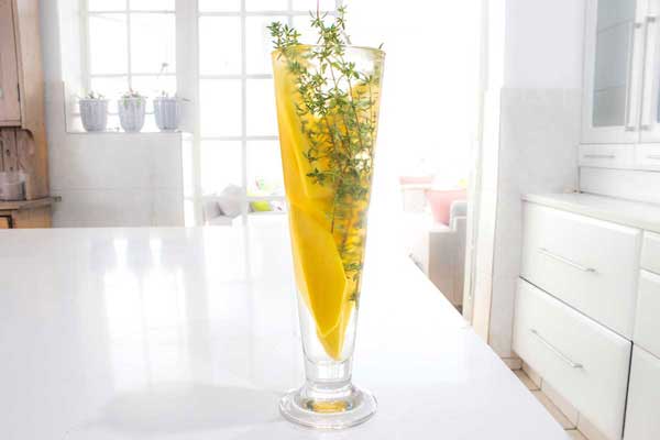 mango and thyme with water in a glass